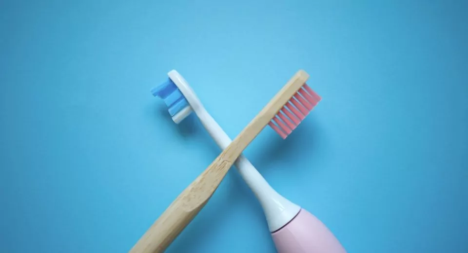two ultrasonic electric toothbrushes on a blue background